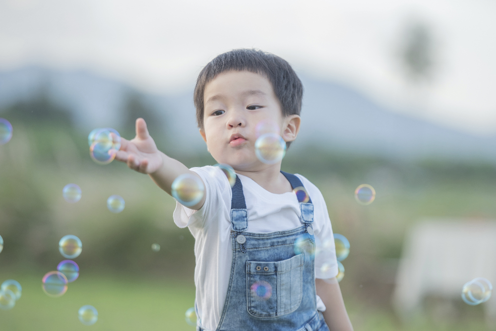 Child playing with bubbles