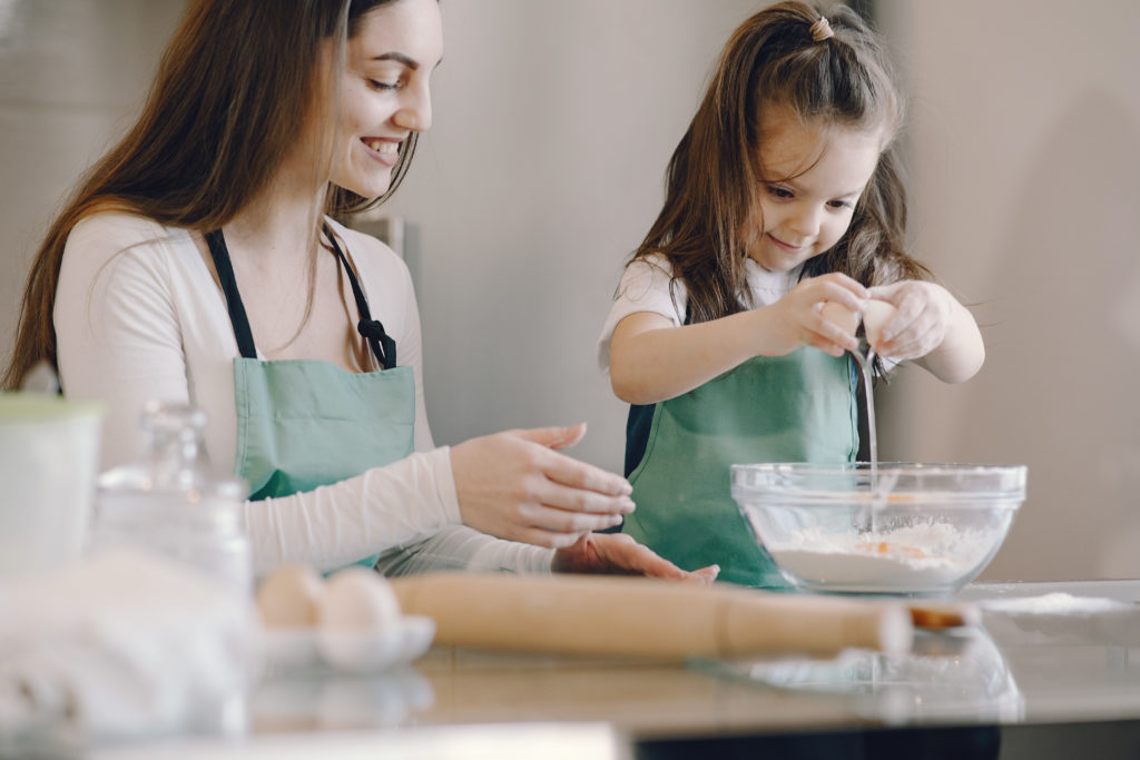 Photo of parent and child baking